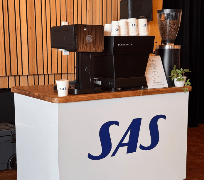 Coffee Cart and Espresso Bar Catering on a counter with 'SAS' branding in a coffee shop setting.