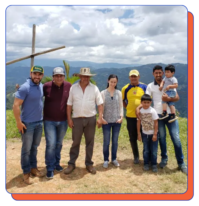 Group of people posing for a photo outdoors with mountains in the background