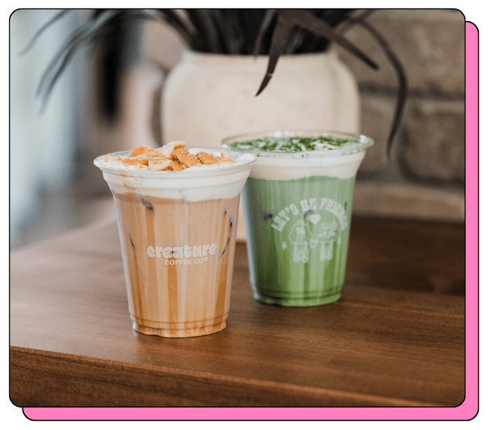 Two beautiful cold foam coffee and matcha drinks from a coffee cart catering service from Creature Coffee, custom cups at this event has the logo