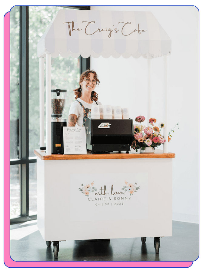 Small coffee catering cart with 'The Craig's Cafe' branding, featuring a smiling barista behind the mobile espresso bar.