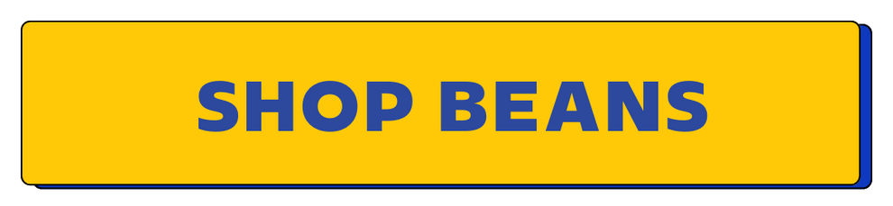 Yellow sign with 'SHOP BEANS' text in blue