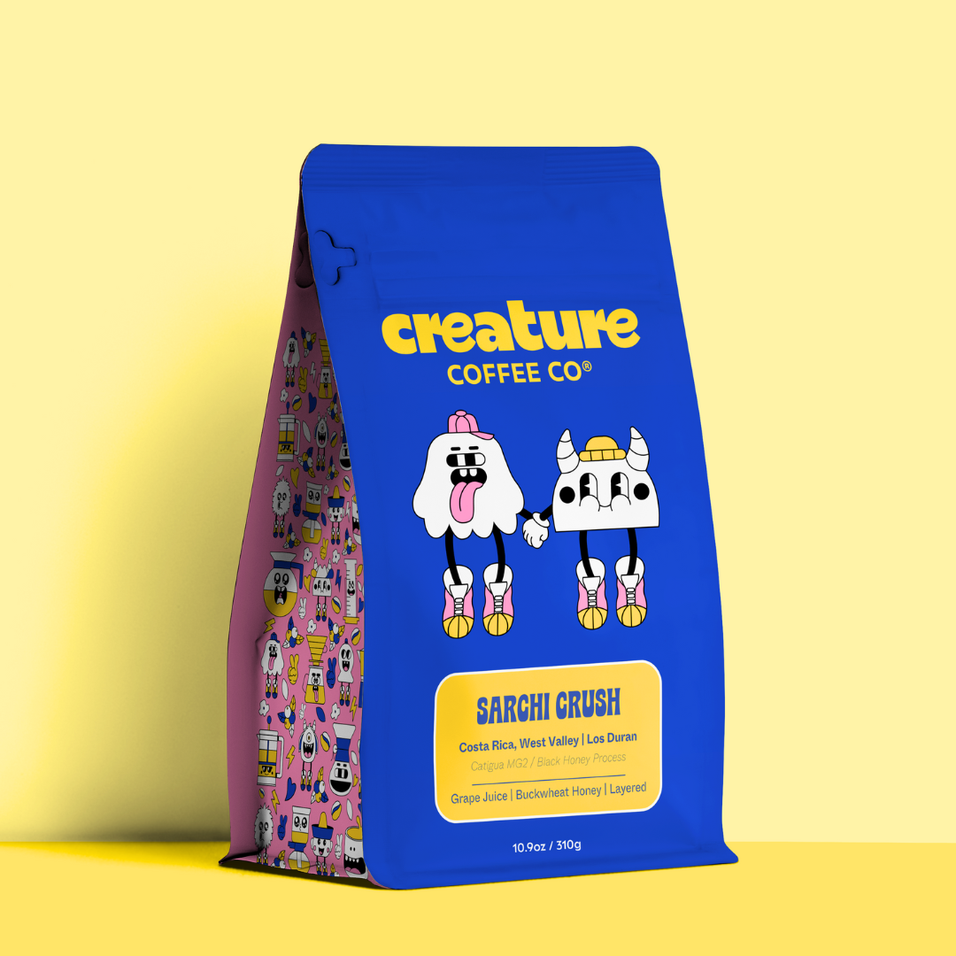 Blue creature coffee bag with cartoon characters and 'Creature Coffee Co' branding on a yellow background. Black Honey Costa Rica Coffee by Los Duran. 
