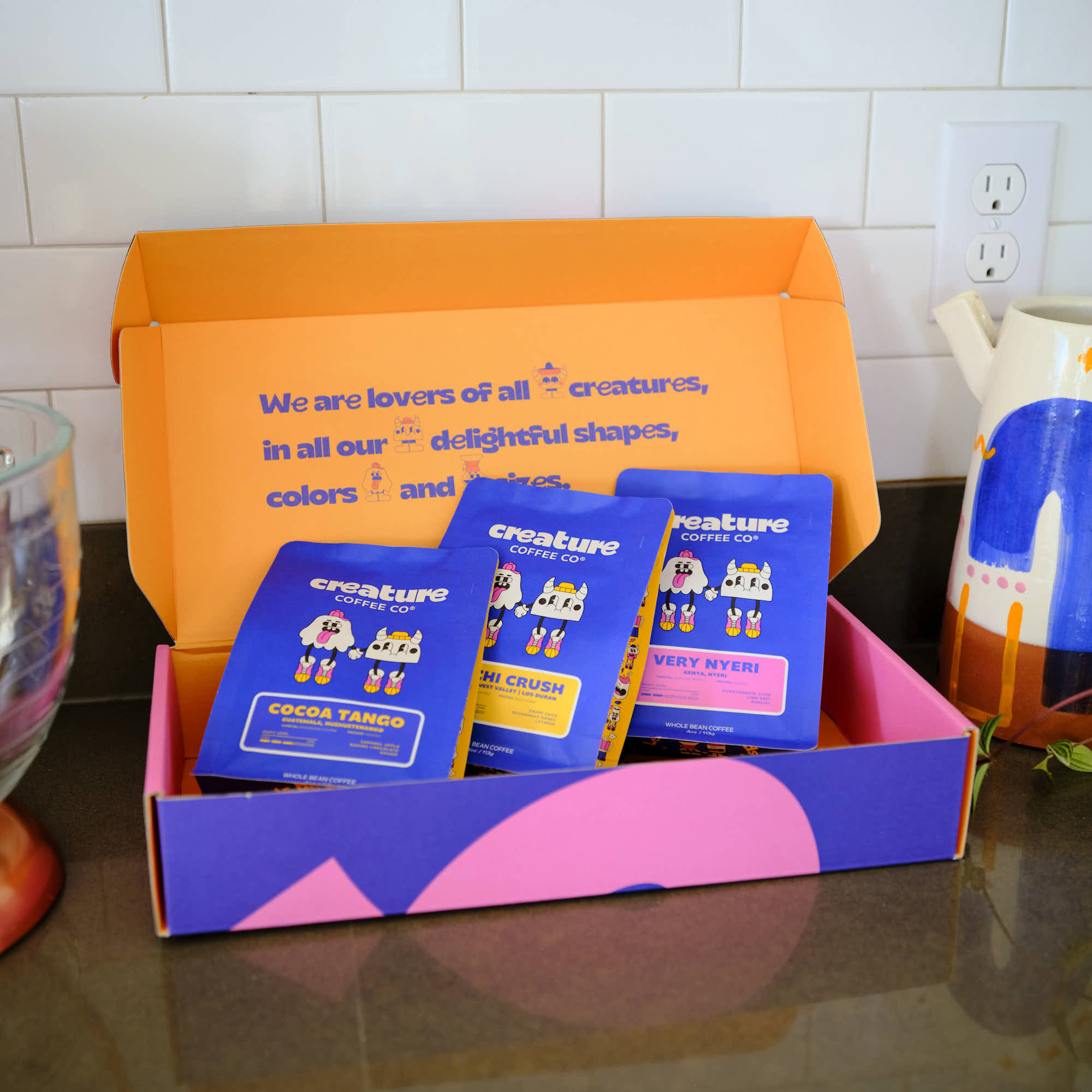 Coffee Gift Box with 'creature coffee' branded products on a kitchen counter