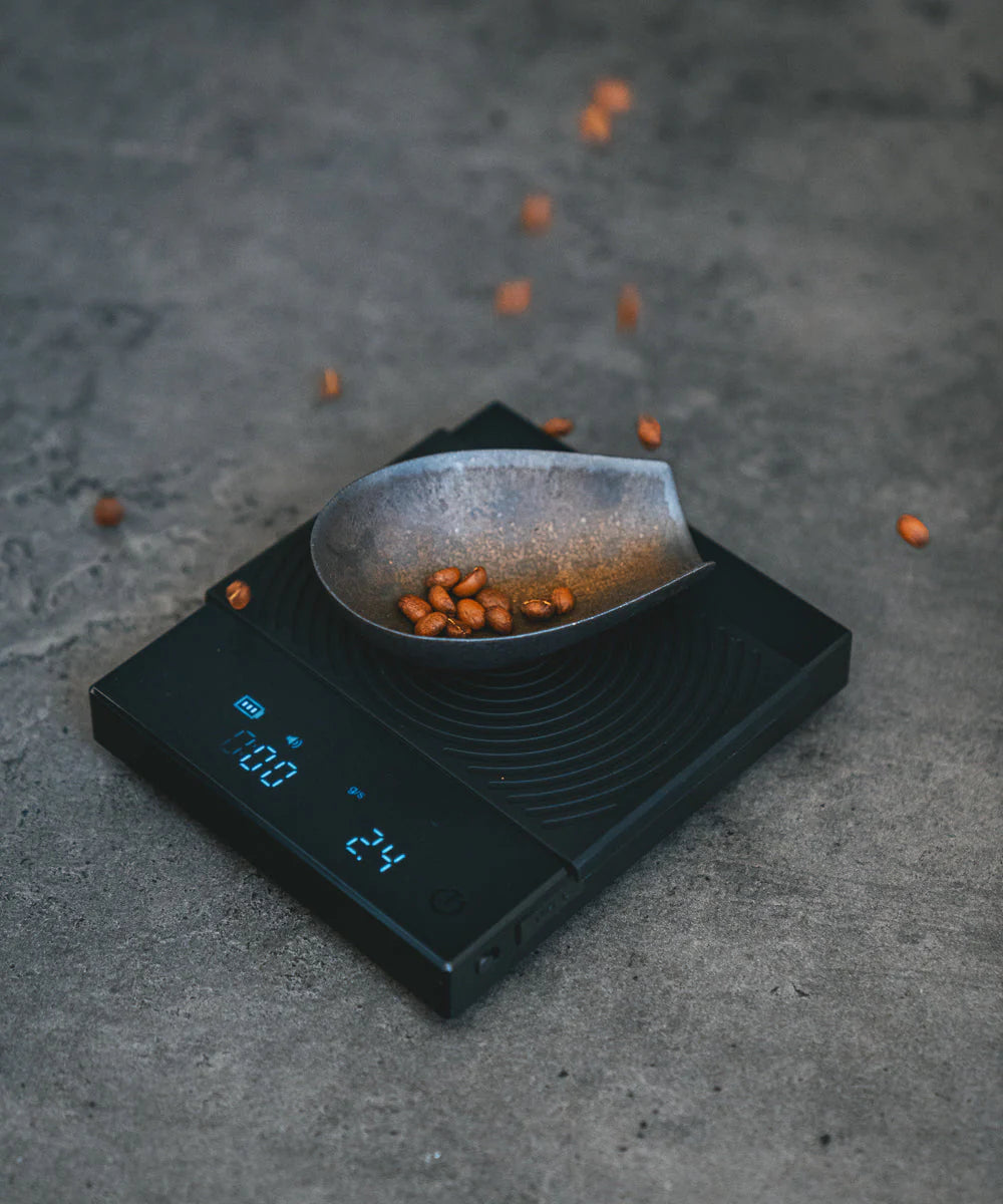 Timemore Black Mirror Basic 2 digital coffee scale used for precise pour over, espresso, and drip coffee brewing at home. Best beans for Home Brewing falling onto scale! 